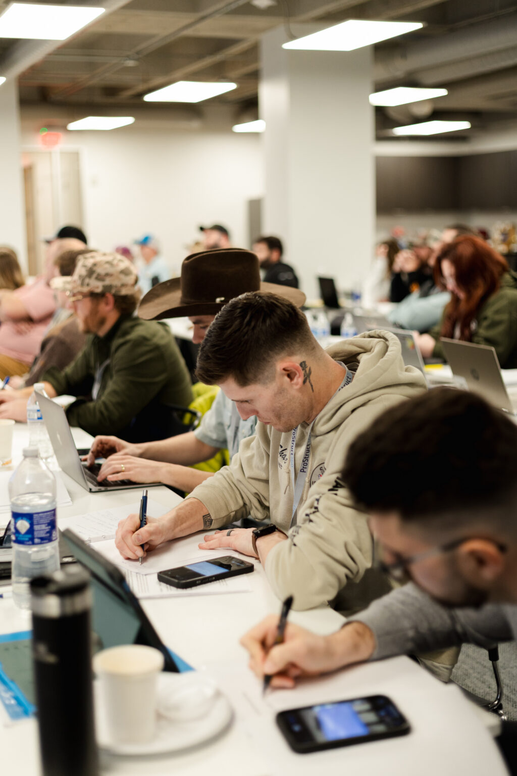 Contractors working through their plans at long tables during the 2026 Growth Retreat.